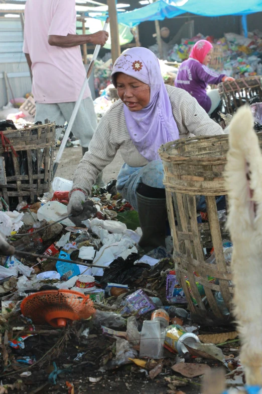 there is a woman and a man next to a bunch of garbage