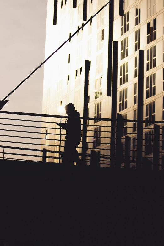 a couple standing by a building on a bridge