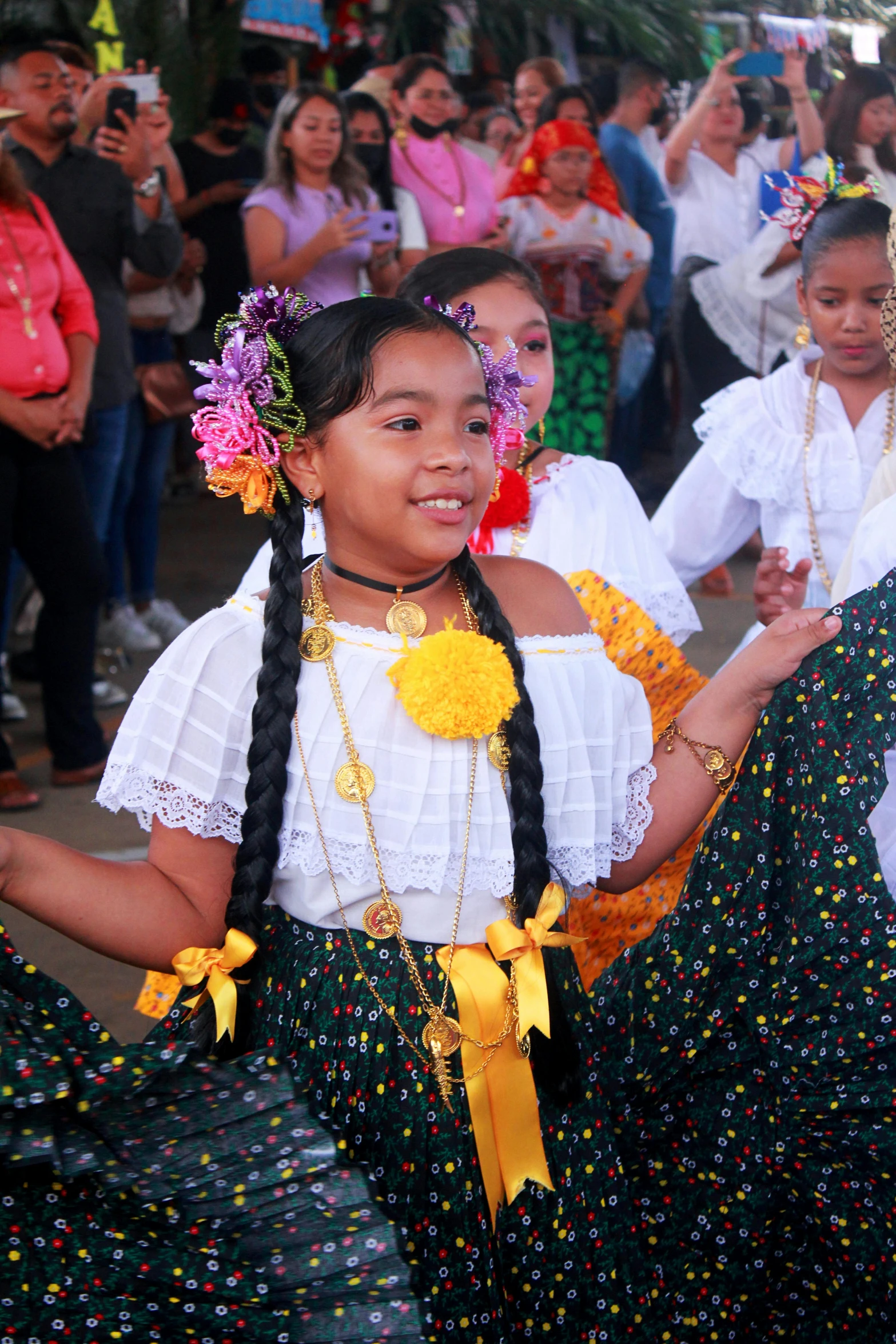 s dressed in colorful attire perform for a group