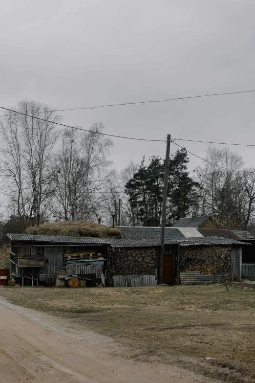 a dirt road near a run down building