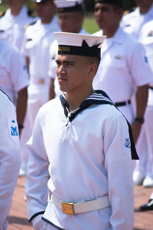 sailors in uniforms, standing on an outdoor platform