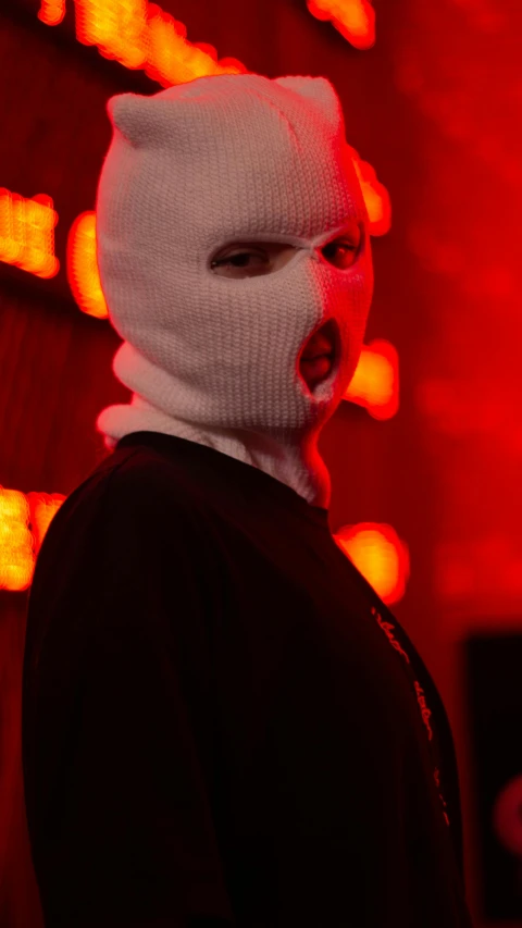 a person is wearing an animal mask with lights in the background