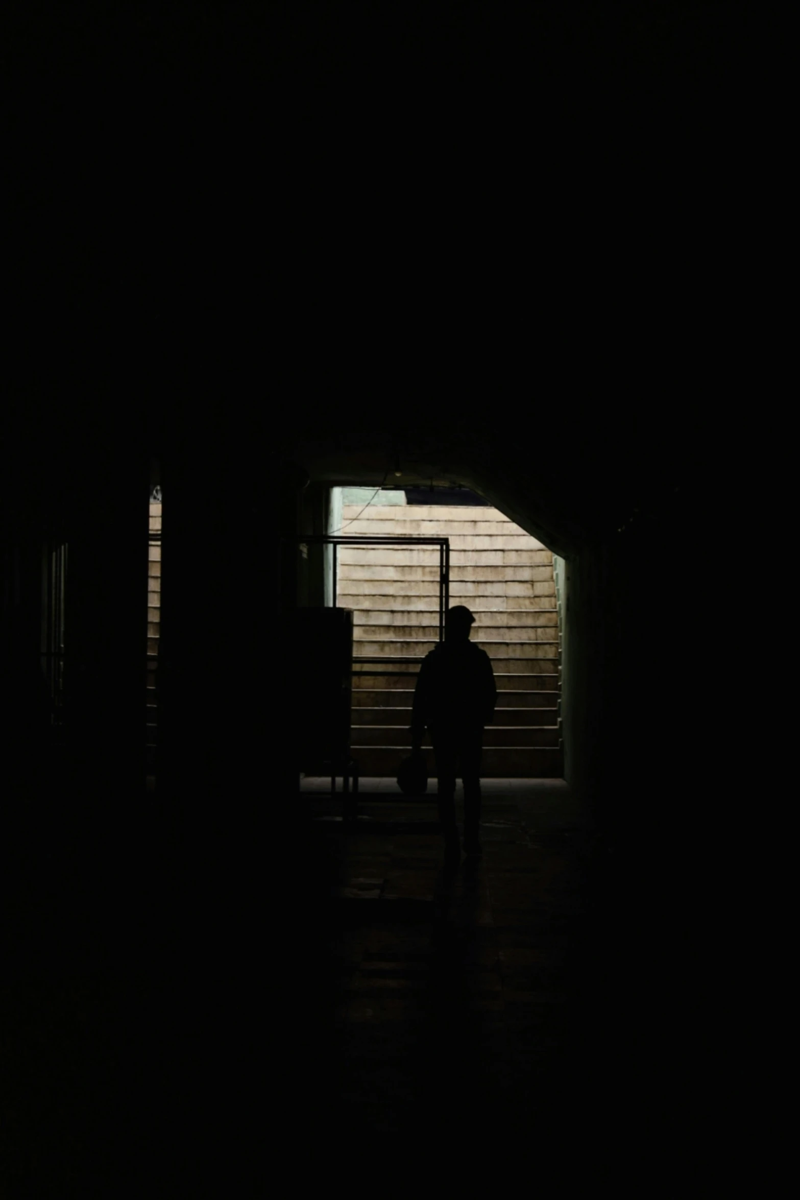 two people are silhouetted against a dark doorway