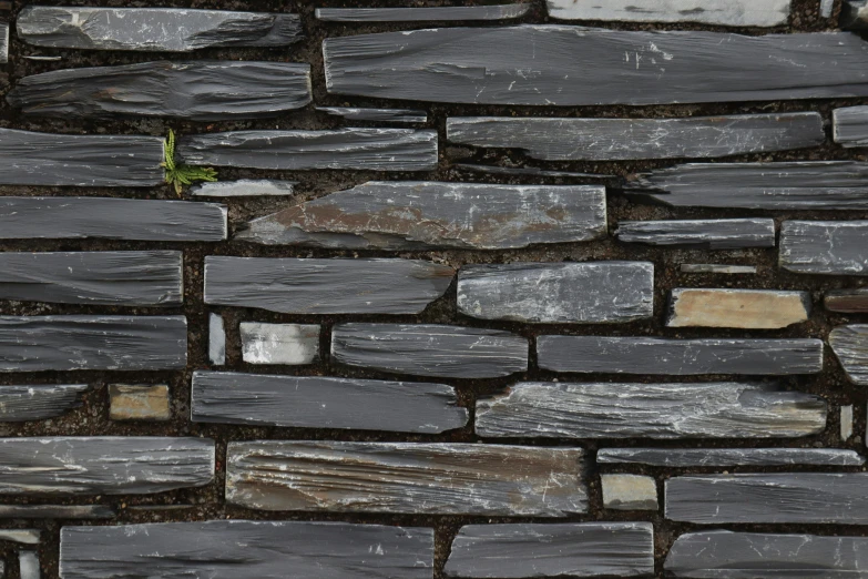 a stone wall is constructed out of multiple small pieces of tile