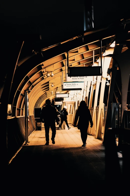 a tunnel with two people walking out of it