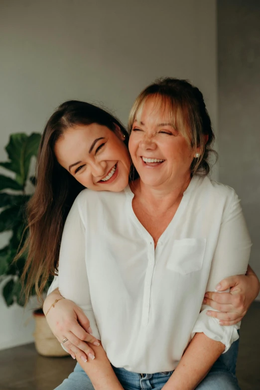 a woman with a laughing face sitting next to a woman