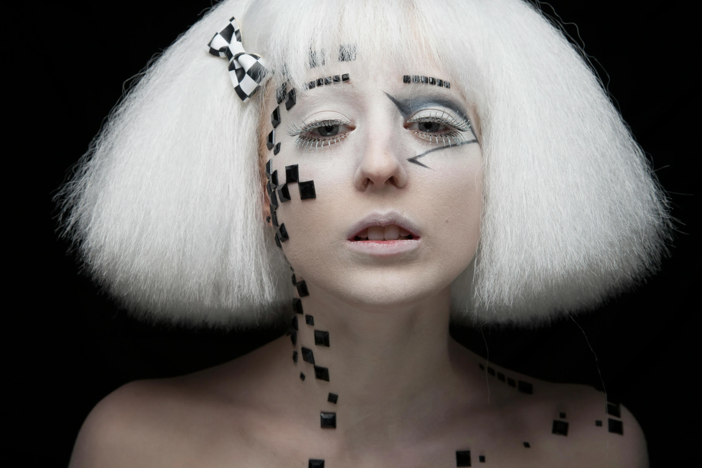 an artistic portrait with white hair and black squares on her face