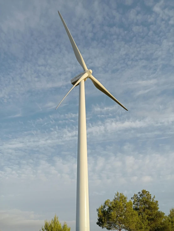 a windmill that is sitting in the grass