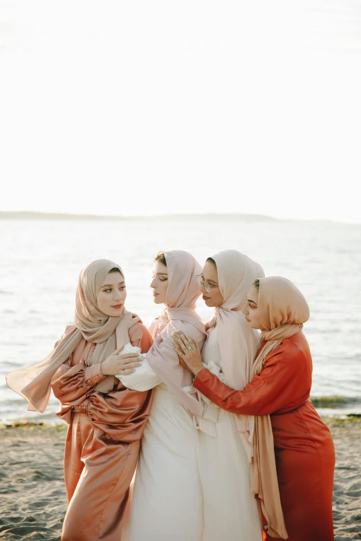 a group of women stand together and talk