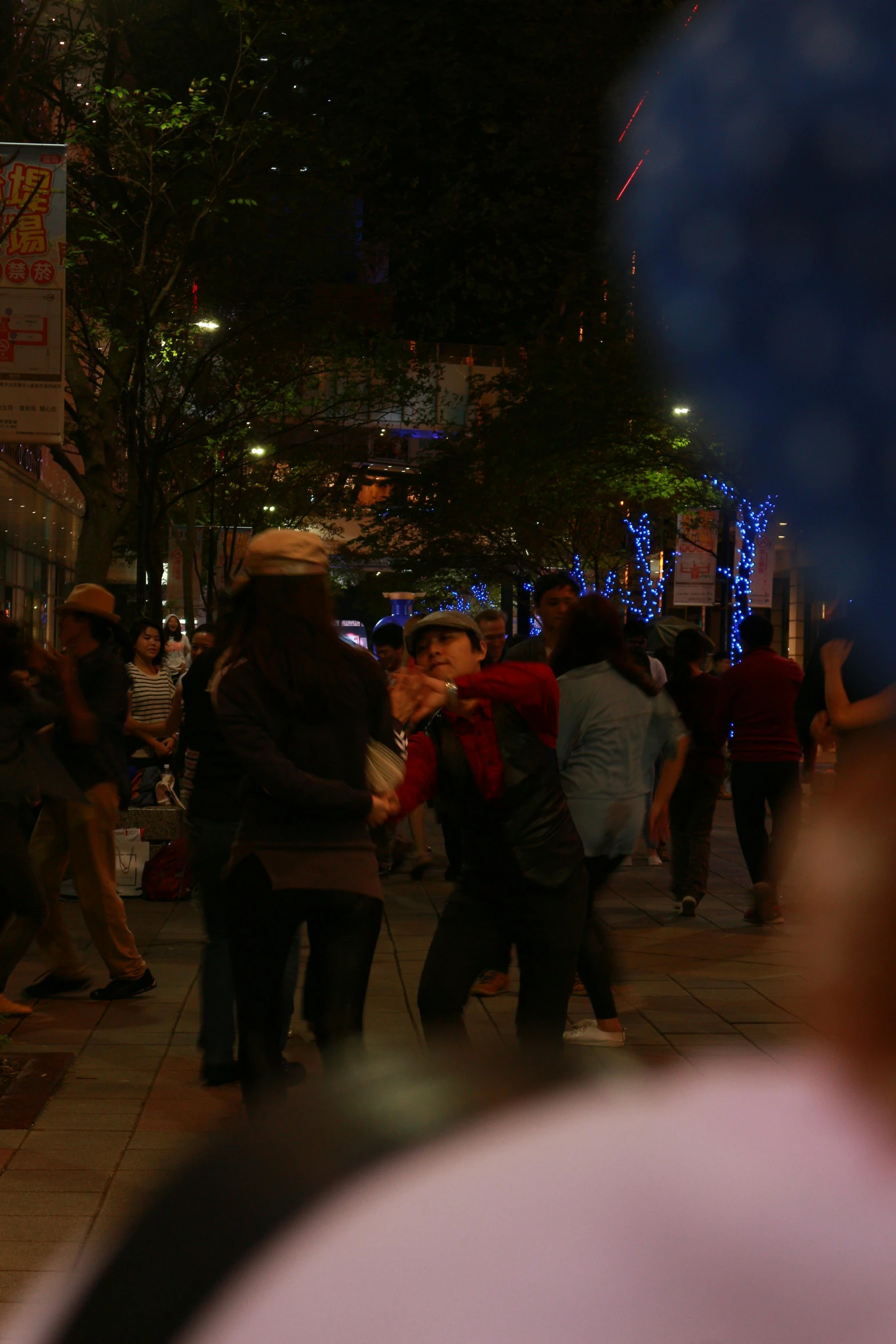 a crowd of people are standing on a city street