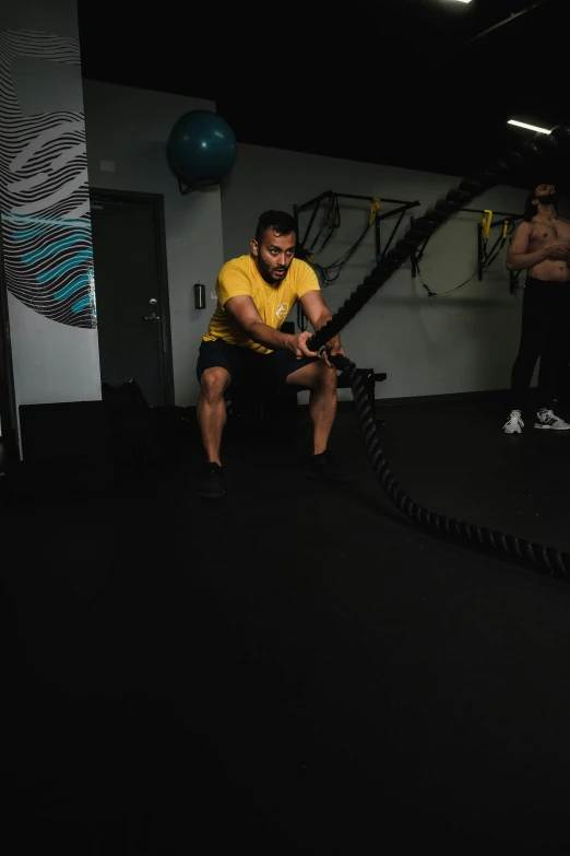 man performing squat exercises in gym