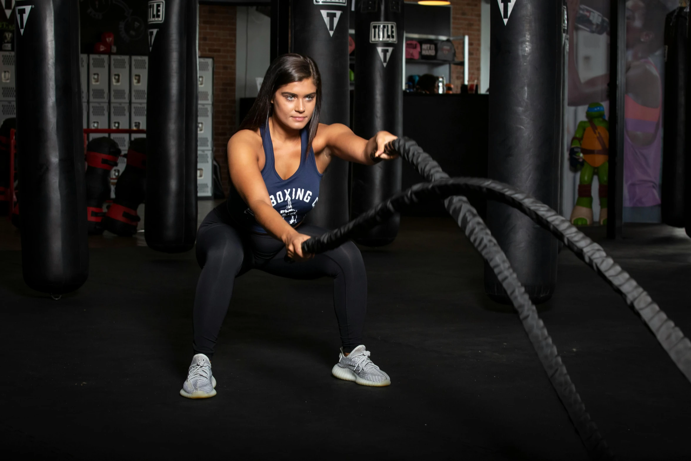 a woman holding a rope in a gym