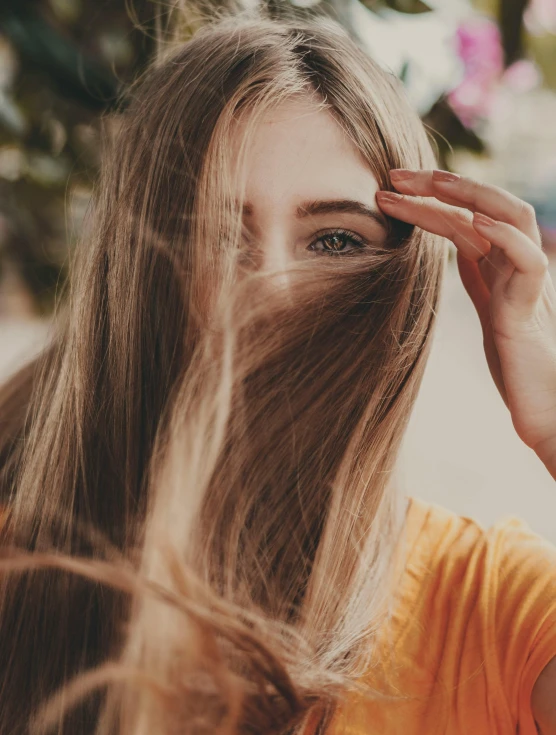 a woman holding her hair to the side