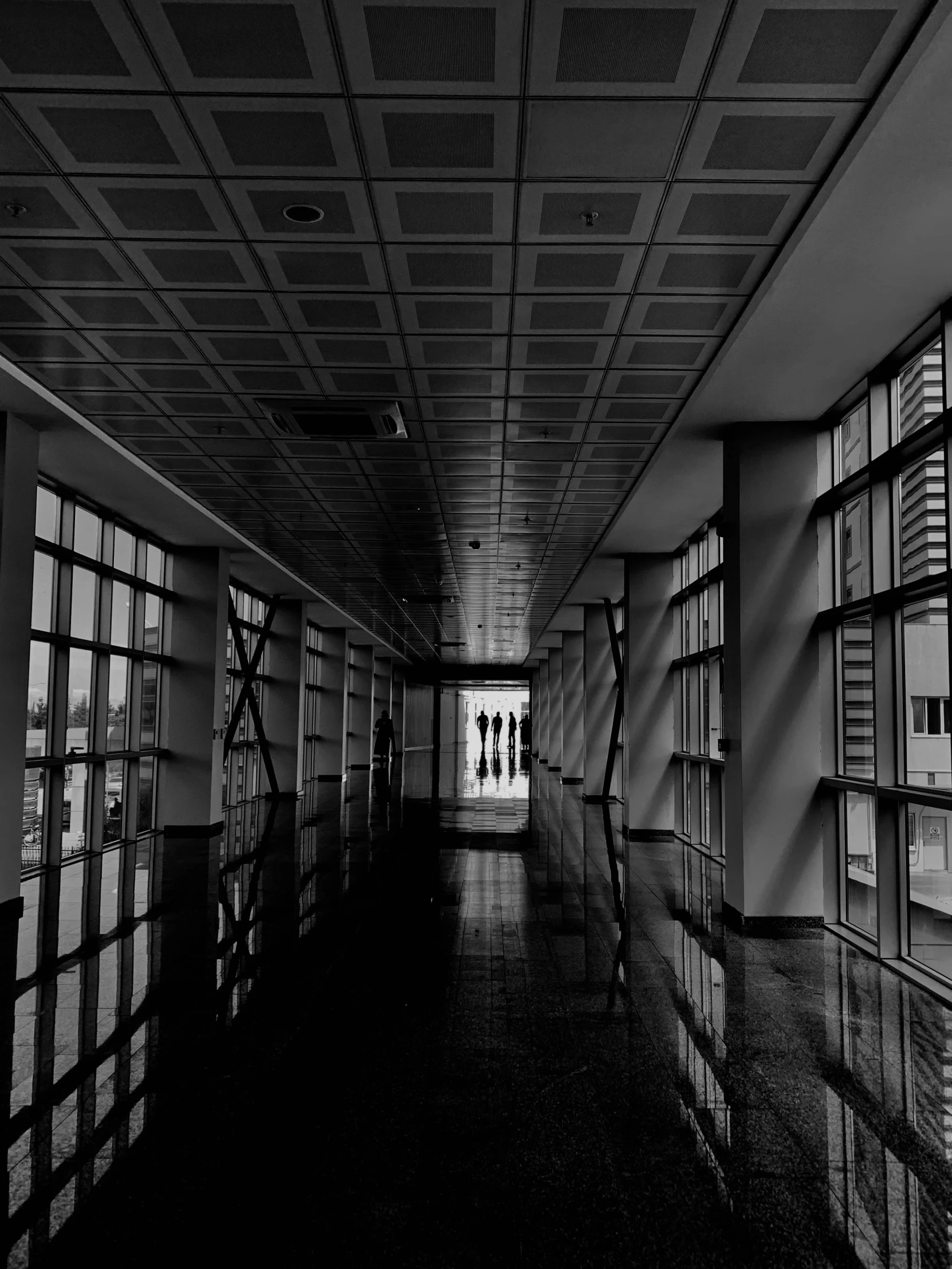 a hallway in the middle of an old building with large open windows