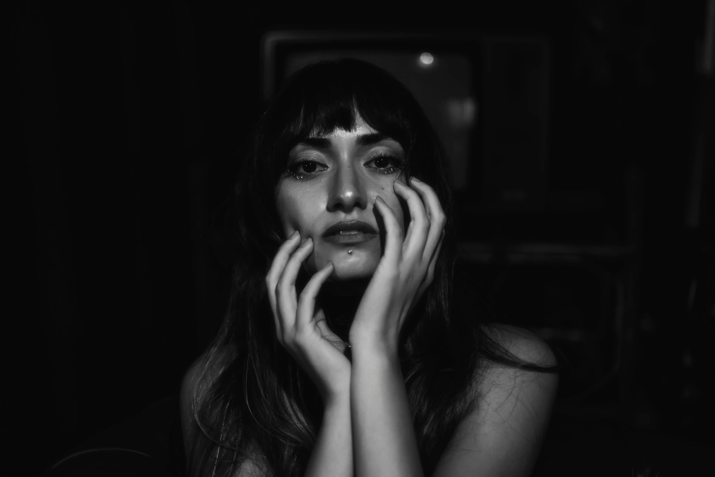 a woman posing for a po in the dark