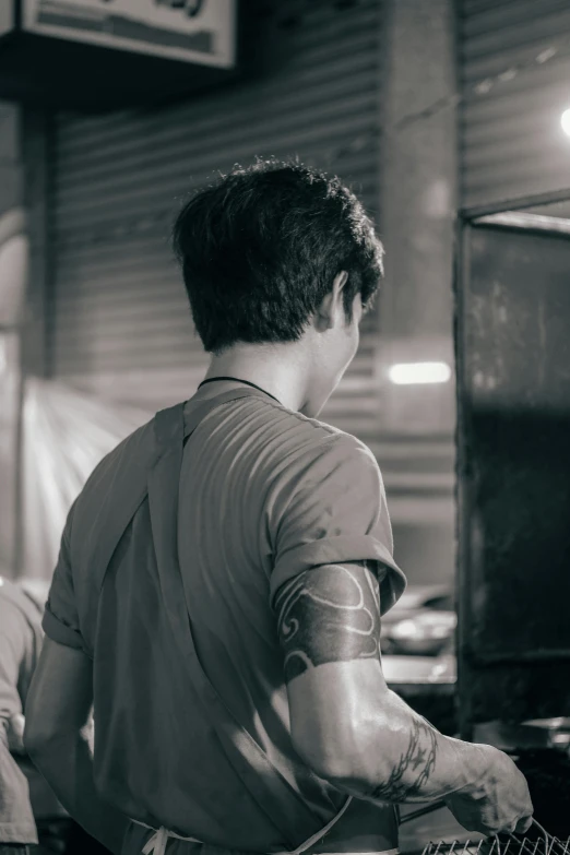 a man cooking food at an indoor grill