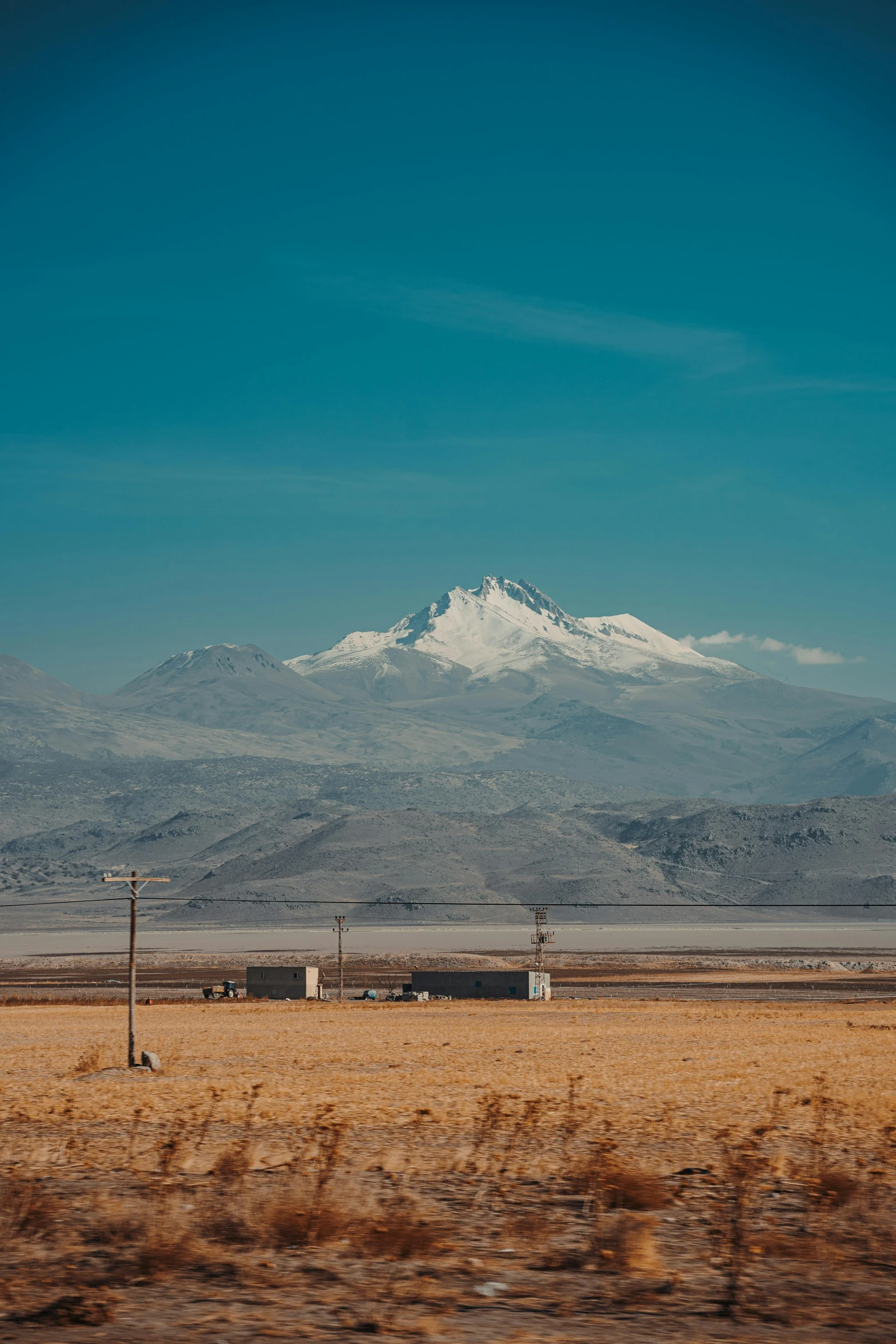 a large snow covered mountain in the distance