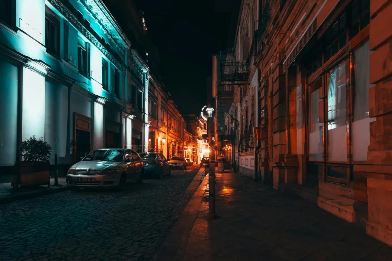 people walking down the street in the city at night