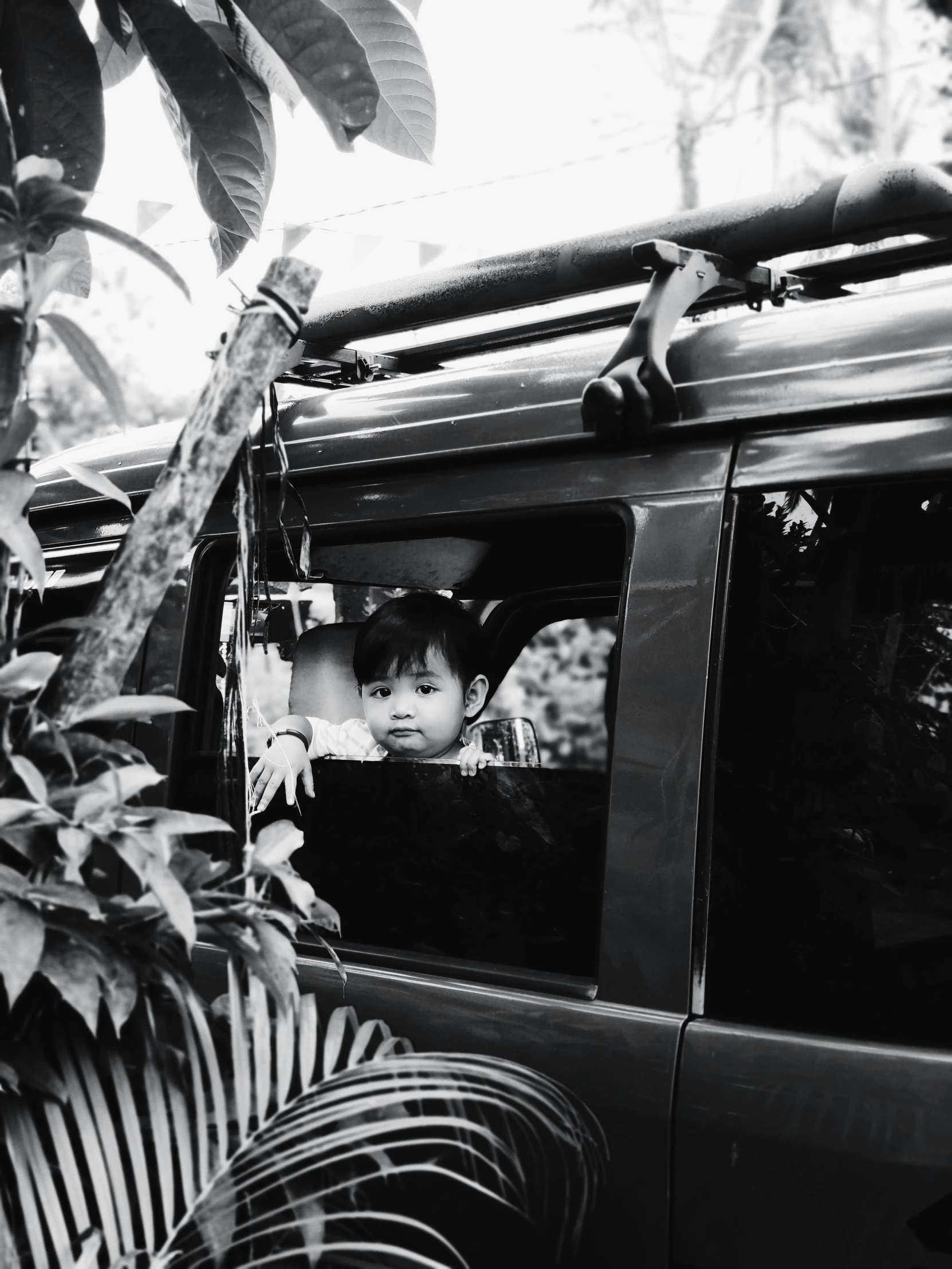 child sitting in the passenger seat of a car