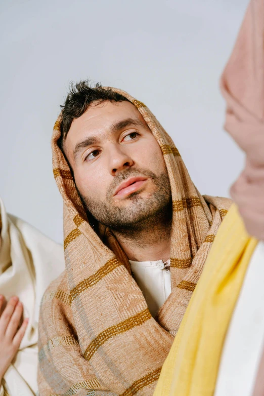 a man is wearing a shawl in a religious scene