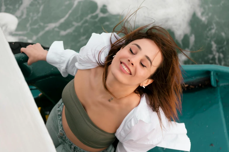 woman laying on the edge of a boat in the water