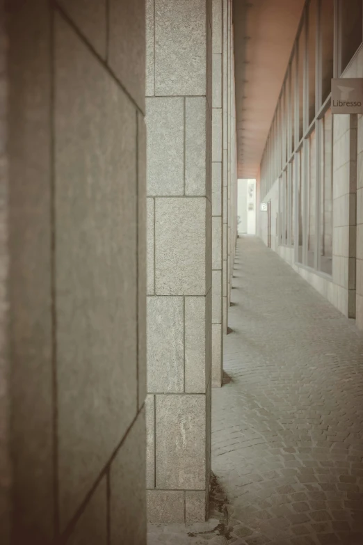 a walkway lined with identical stone columns