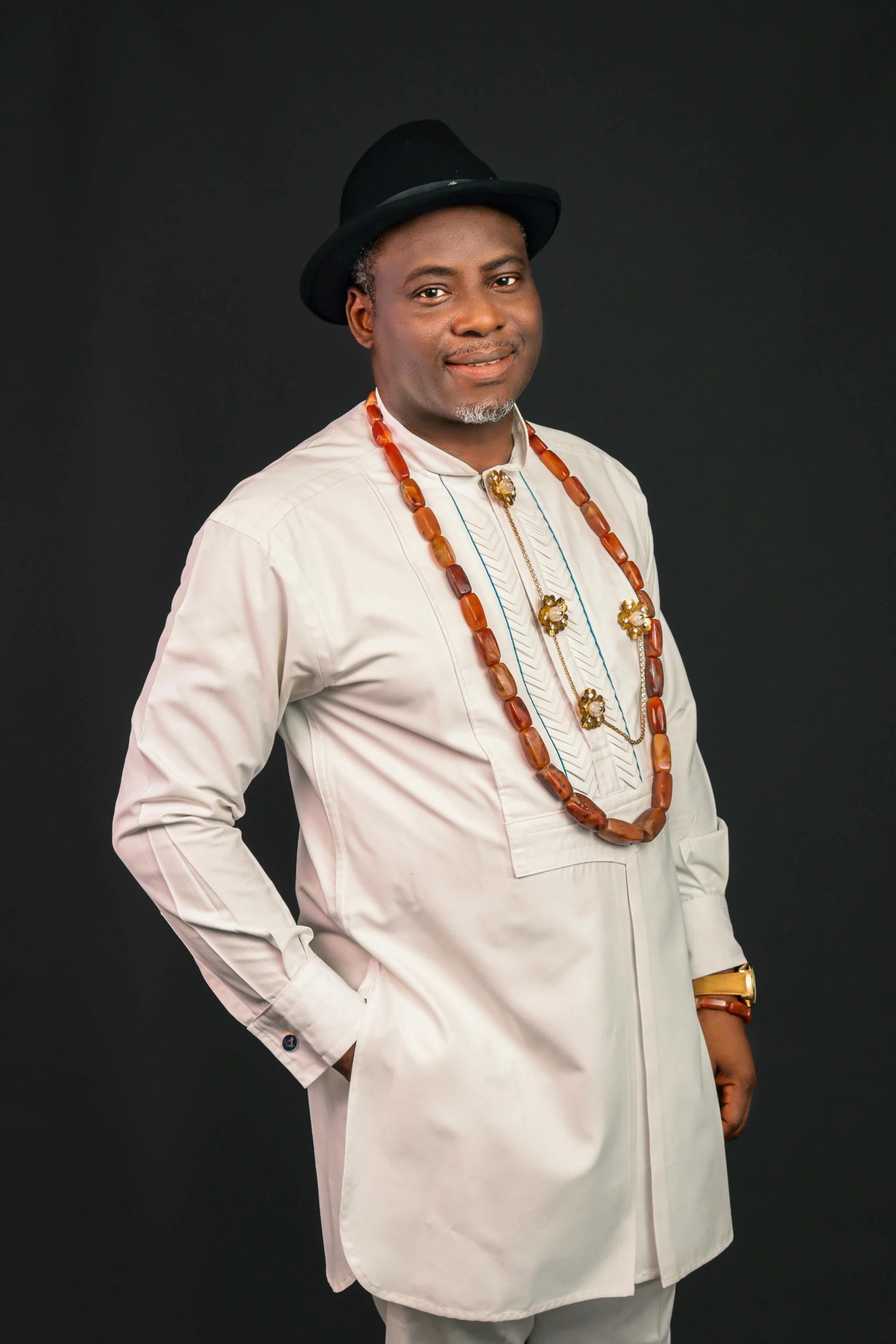 a man in white with beads around his neck