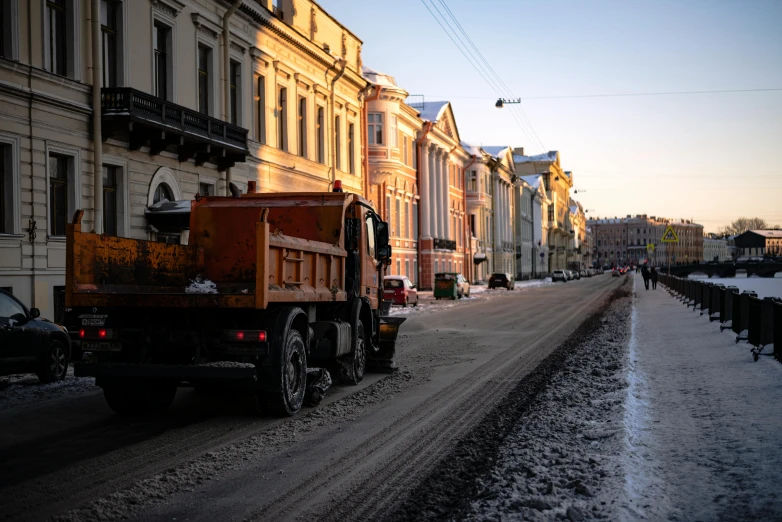 some cars are parked on the side of a snowy road