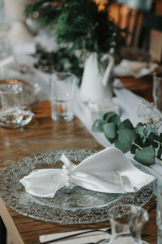 a dinner table set with flowers and dishes