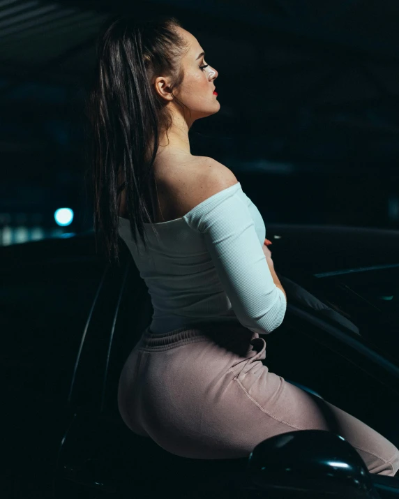 a woman is standing next to a car