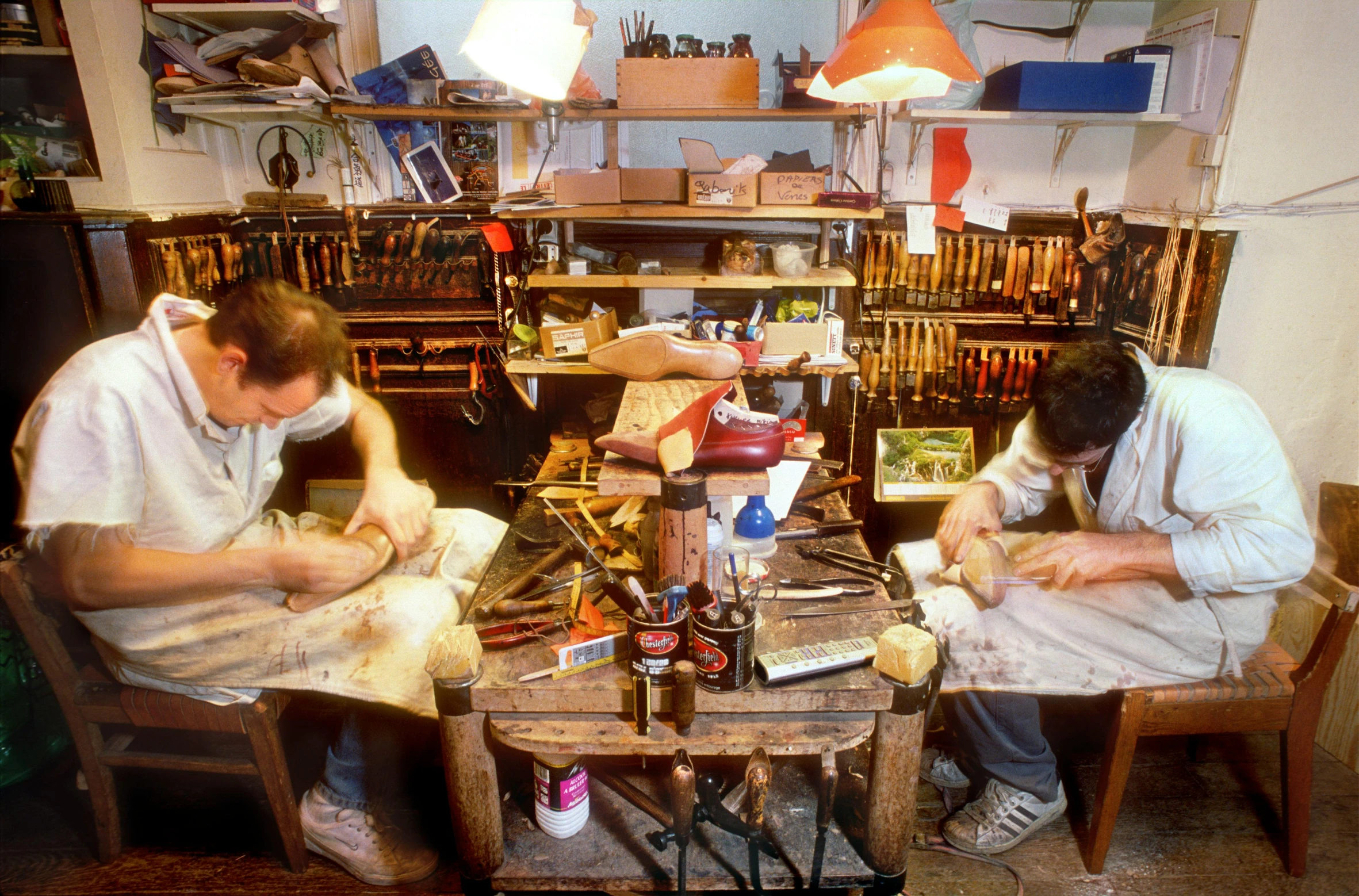 a couple of men working on paper and crafting