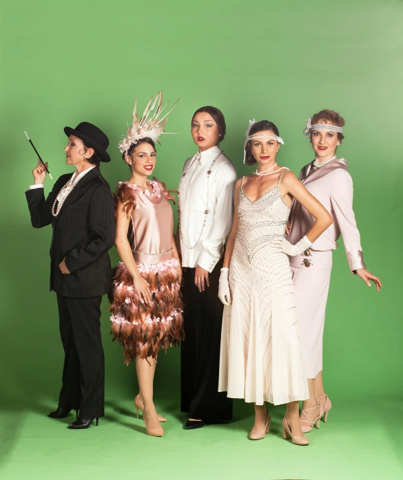 four young ladies dressed in fancy clothing pose for a pograph