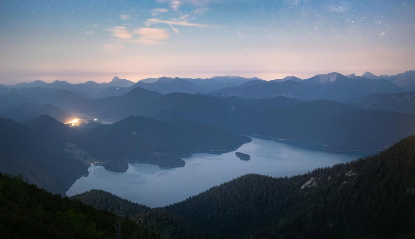 a full view of the night sky with mountains in the foreground