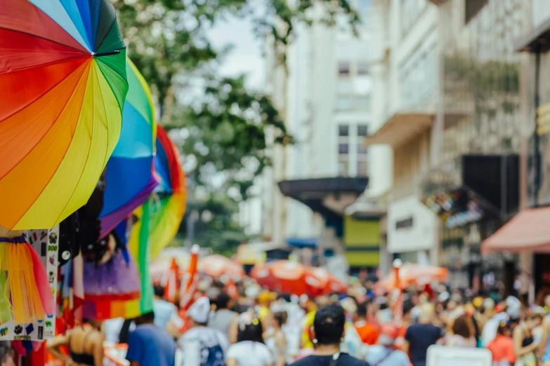 some people with colorful umbrellas and buildings