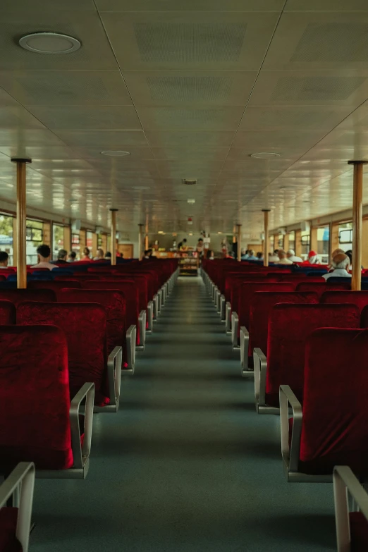 some red chairs and tables on a long train