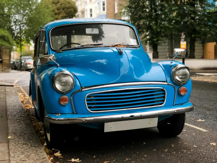 an old style car parked next to a building