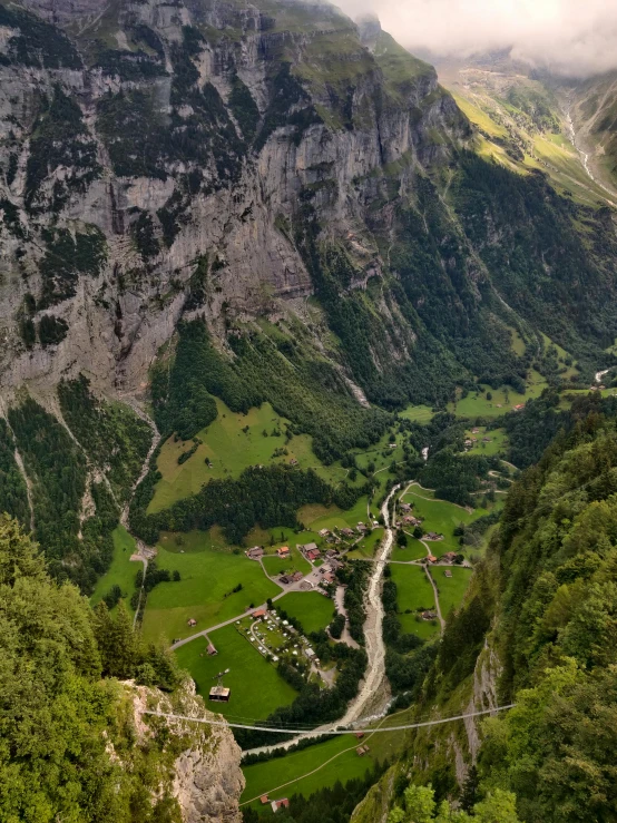 a narrow road in the mountains with valleys on both sides