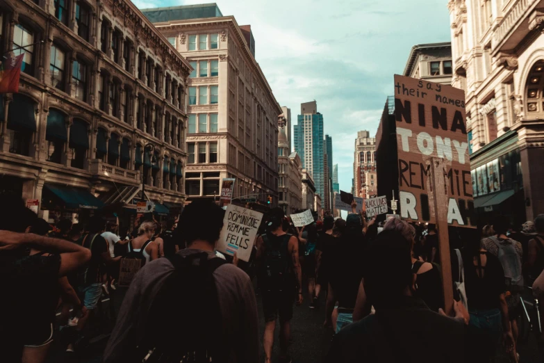 a city street filled with people protesting