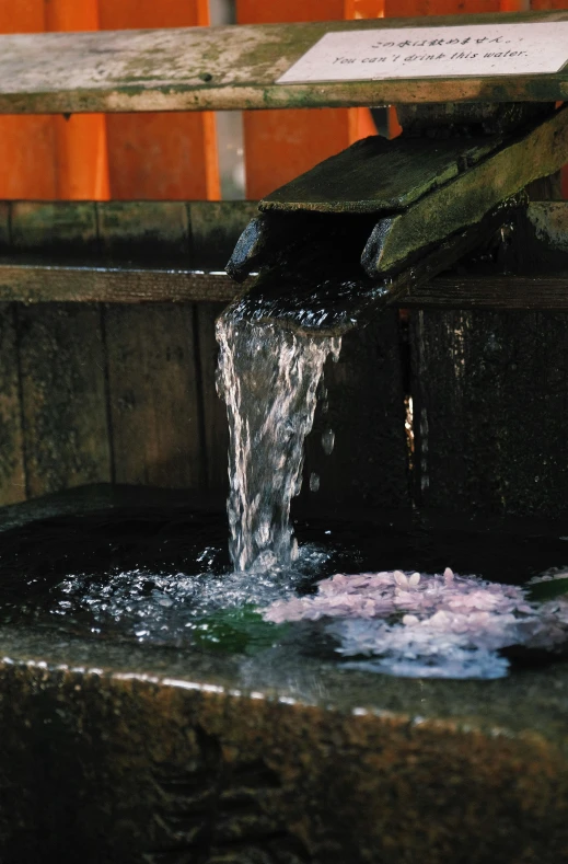 water falling from an open pipe in a fountain