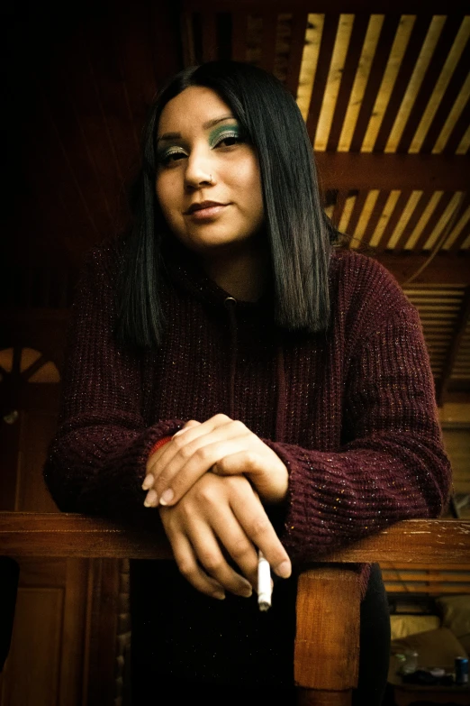 a woman leaning on her arm holding a cigarette