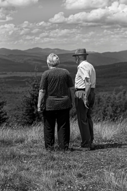 two people standing on the top of a mountain