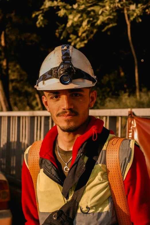 a man wearing a white safety helmet and safety equipment