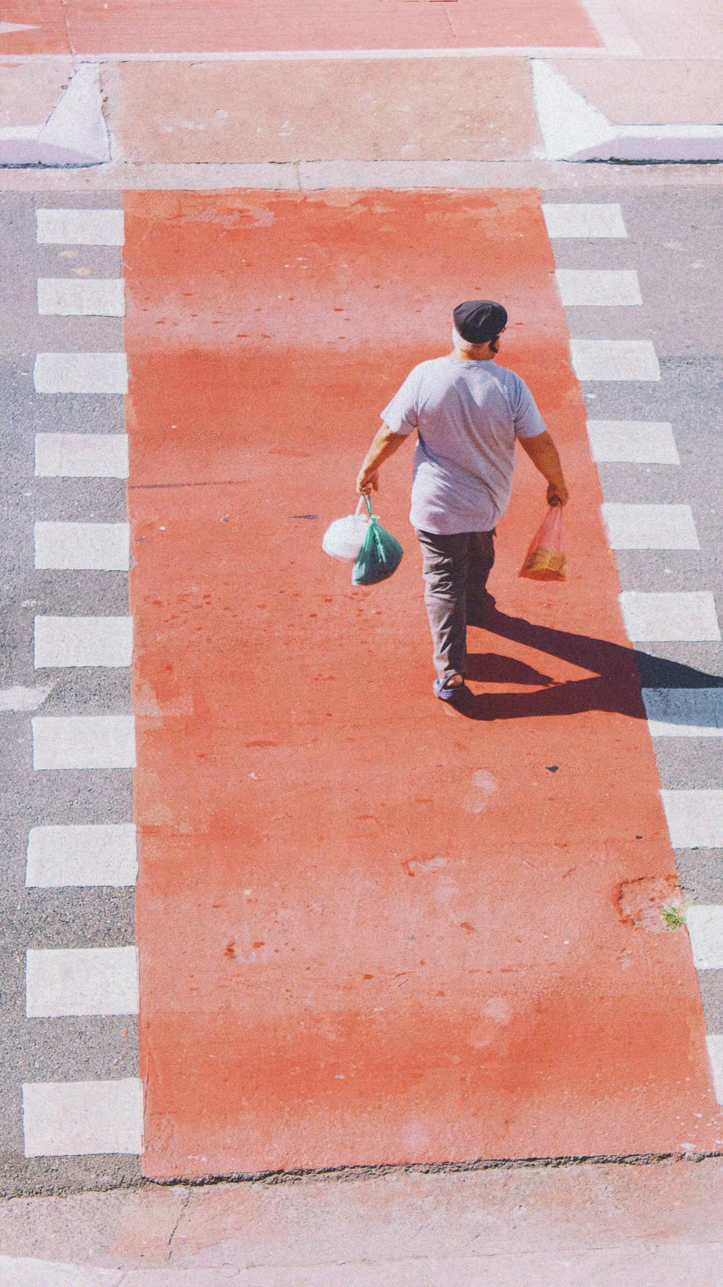 a man is walking across the street in white