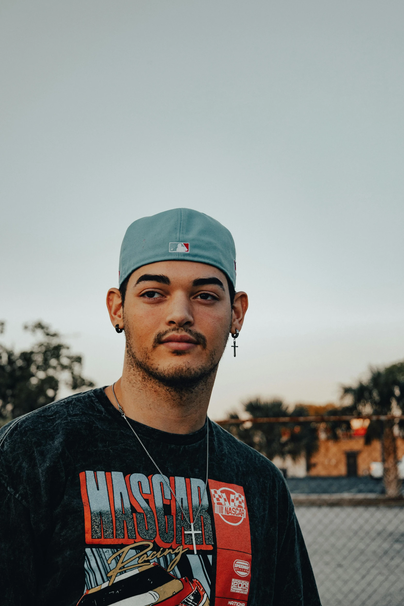 man in black and blue t - shirt standing outdoors