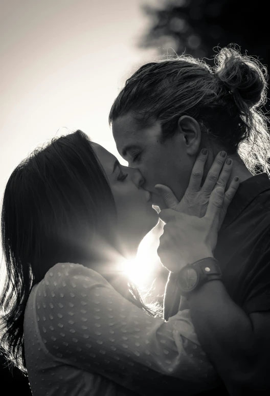 two people with their eyes shut kissing each other