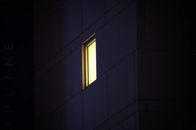 the light is shining through a window in a dark building