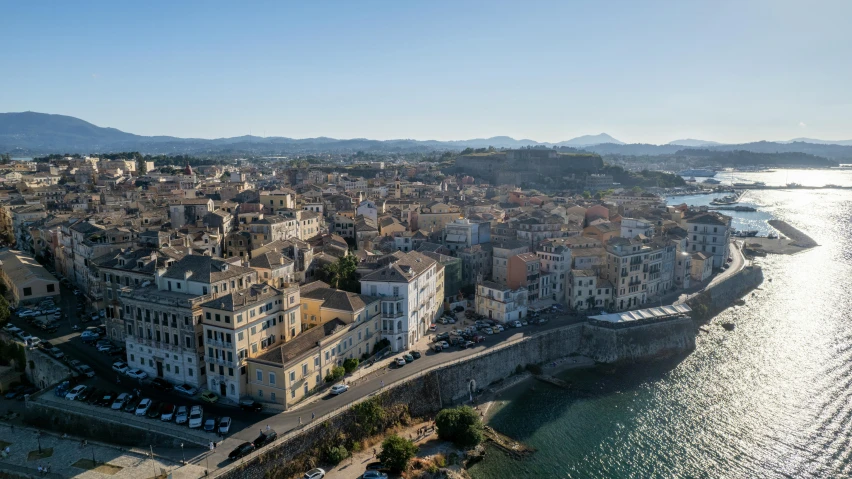 aerial view of a city by the water in the sun