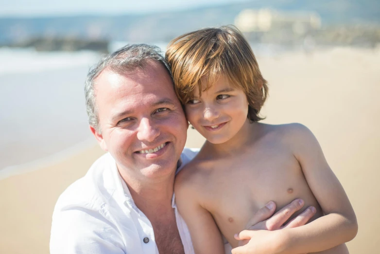 a man and a child sitting on top of each other