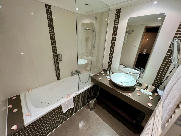 a bath room with a big mirror and a sink