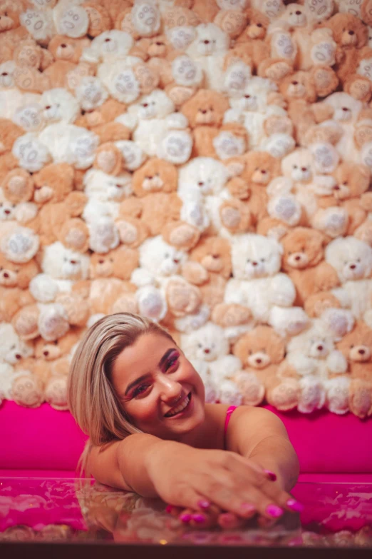 a woman posing in front of a group of teddy bears